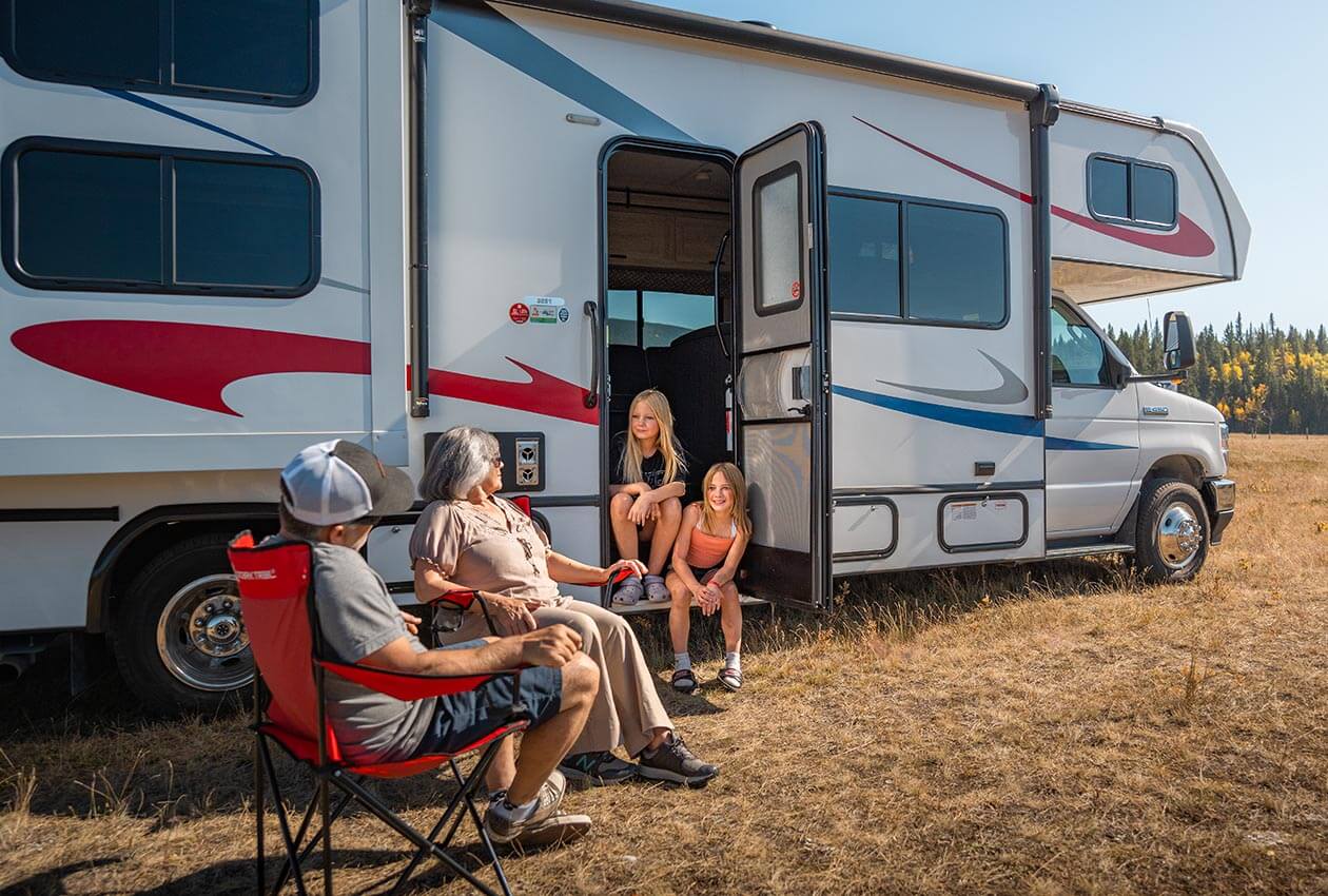 Family enjoying evening drinks beside 澳洲幸运5开奖结果体彩网 CanaDream RV